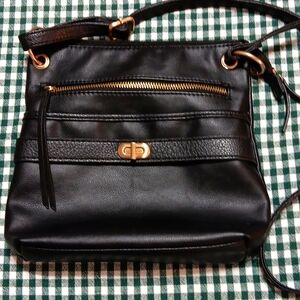 Black Faux leather shoulder/crossover bag, 9 in wide by 20 in tall. EUC